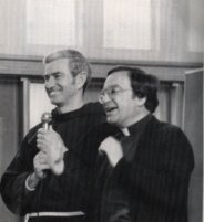 Fr Gabriel Calvo and Fr Donnon Murray OFM speaking together at a FIRES programme (black-and-white photo)