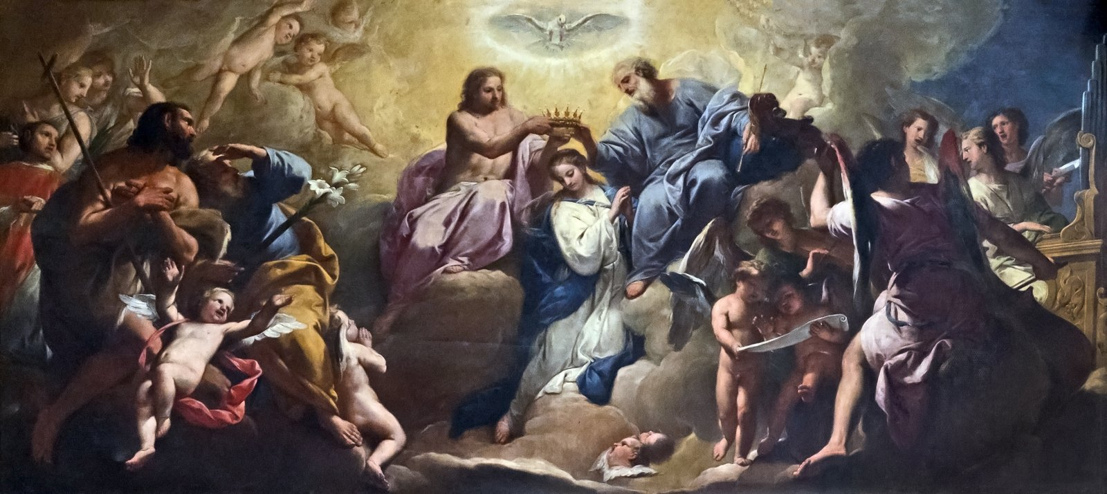 La Coronación de la Virgen de Gregorio Lazzarini: la Virgen María, arrodillada, es coronada por Cristo y Dios Padre bajo la paloma del Espíritu Santo, rodeada de santos, querubines y ángeles músicos